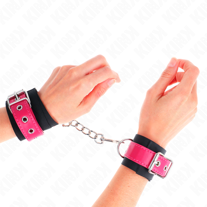KINK - BLACK NYLON WRIST RESTRAINTS WITH ADJUSTABLE RASPBERRY PINK FAUX LEATHER BELT 19-29 CM X 5.1 CM